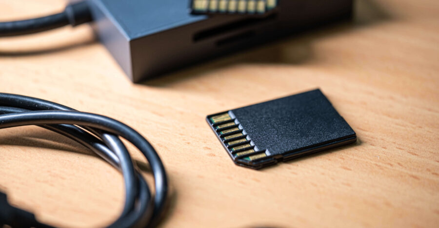 sd-memory-cards-and-card-reader-on-wooden-surface-2024-11-25-06-56-14-utc